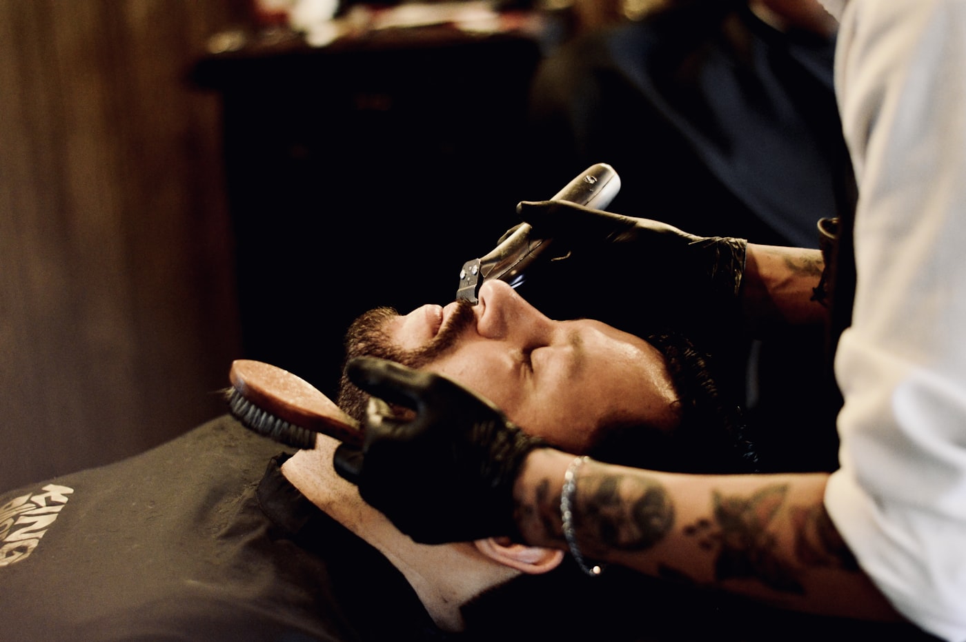 A hot-towel straight razor shave in progress at the barber chair
