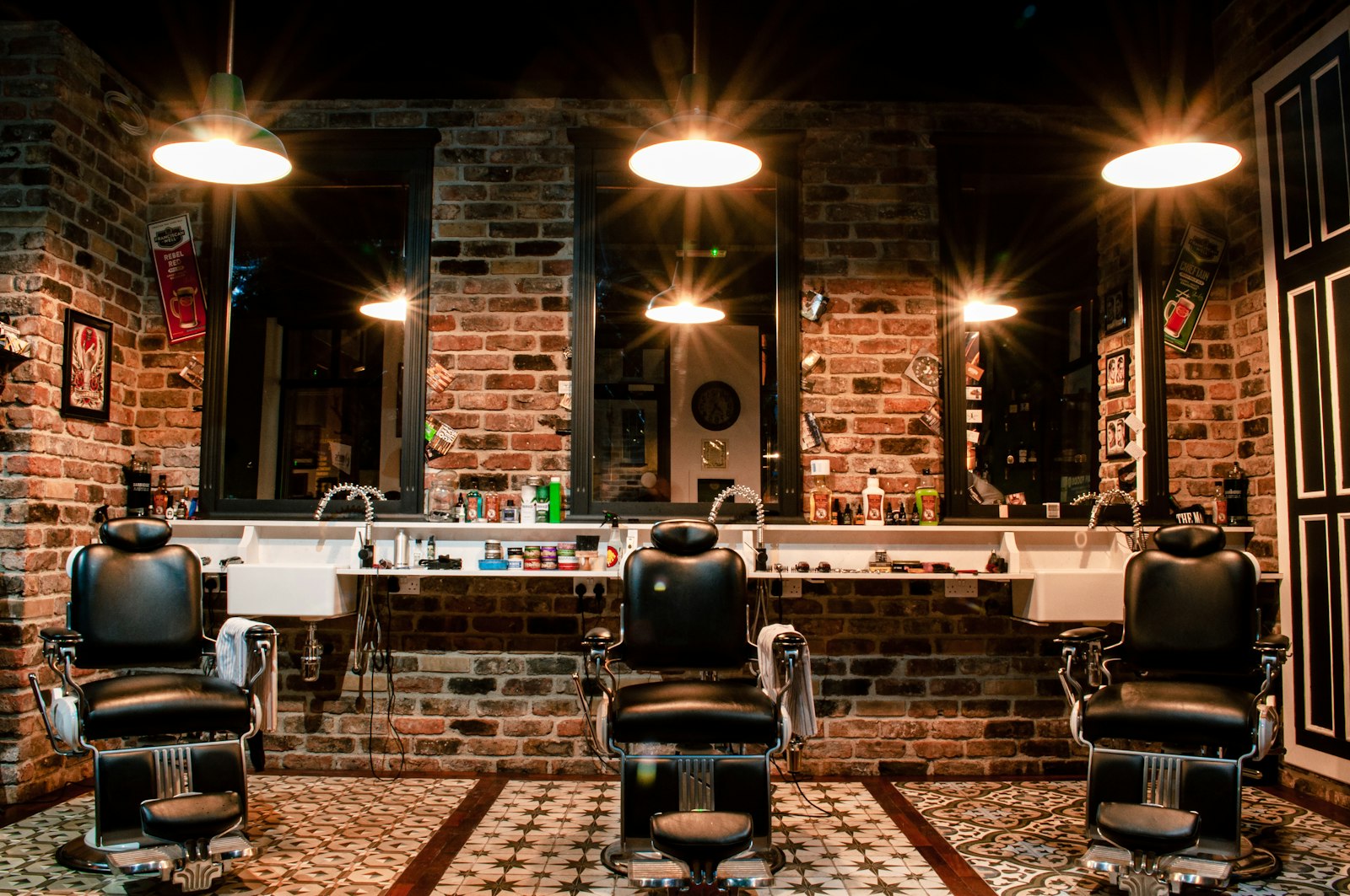 The Kingfisher shop floor: a row of leather barber chairs under warm pendant lamps